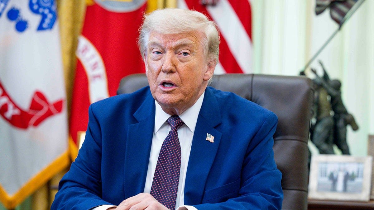 President Donald Trump signing an executive order in the Oval Office of the White House