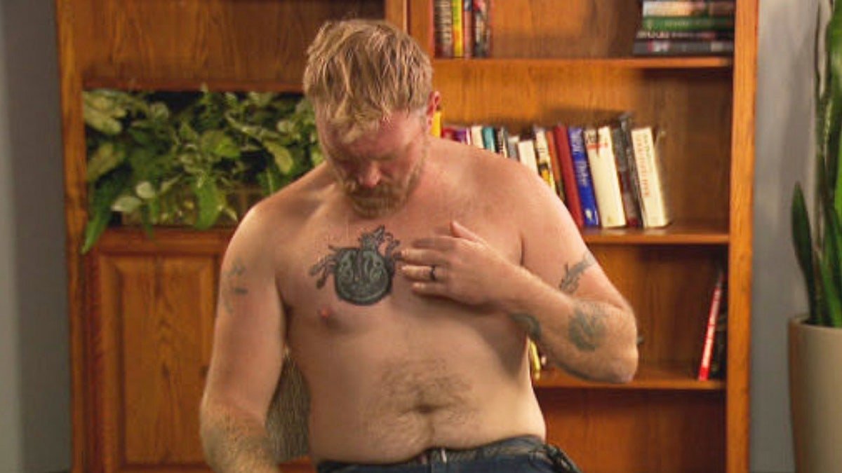 In this photo provided by WGME, Graham Platner, a Democratic candidate for U.S. Senate in Maine, points to a cover-up tattoo that had previously been an image recognized as a Nazi symbol, during an interview on Wednesday, Oct. 22, 2025, in Portland, Maine.