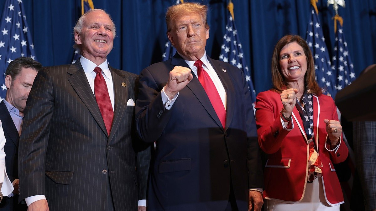 South Carolina Gov. Henry McMaster, Donald Trump, and Lt. Gov. Pamela Evette standing on stage at an election night watch party.