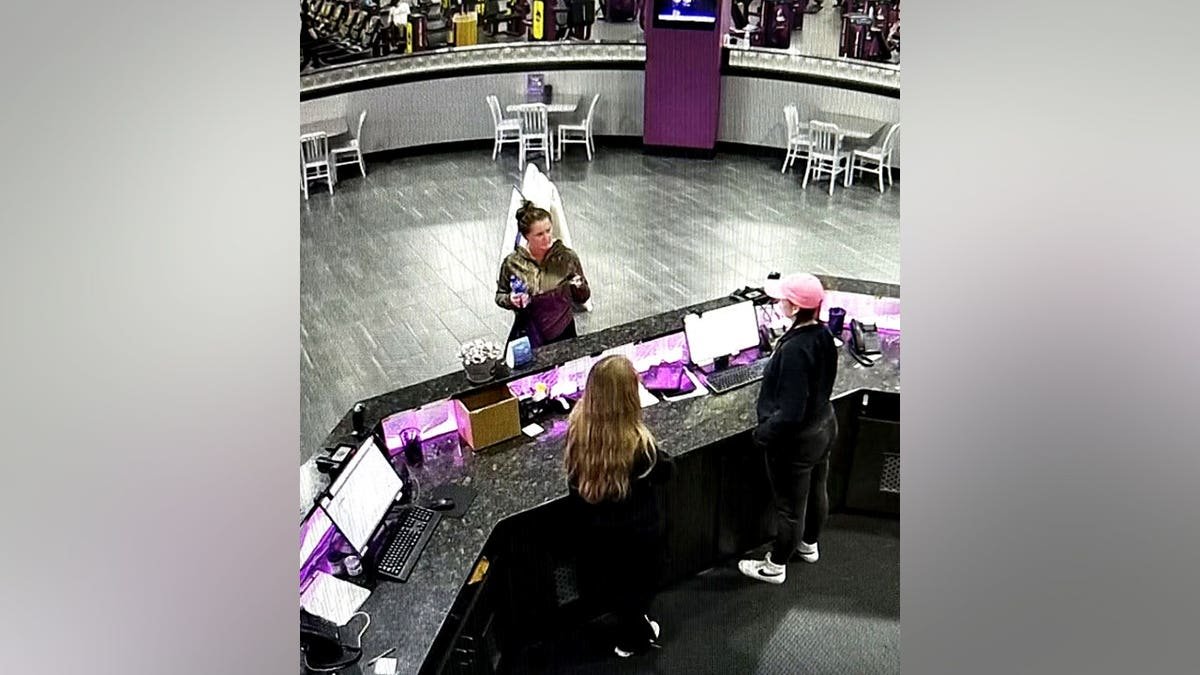 Elena Katherine Moore at the desk of a Planet Fitness before she disappeared