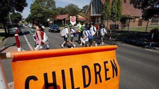 Children cross the road in a school zone. 