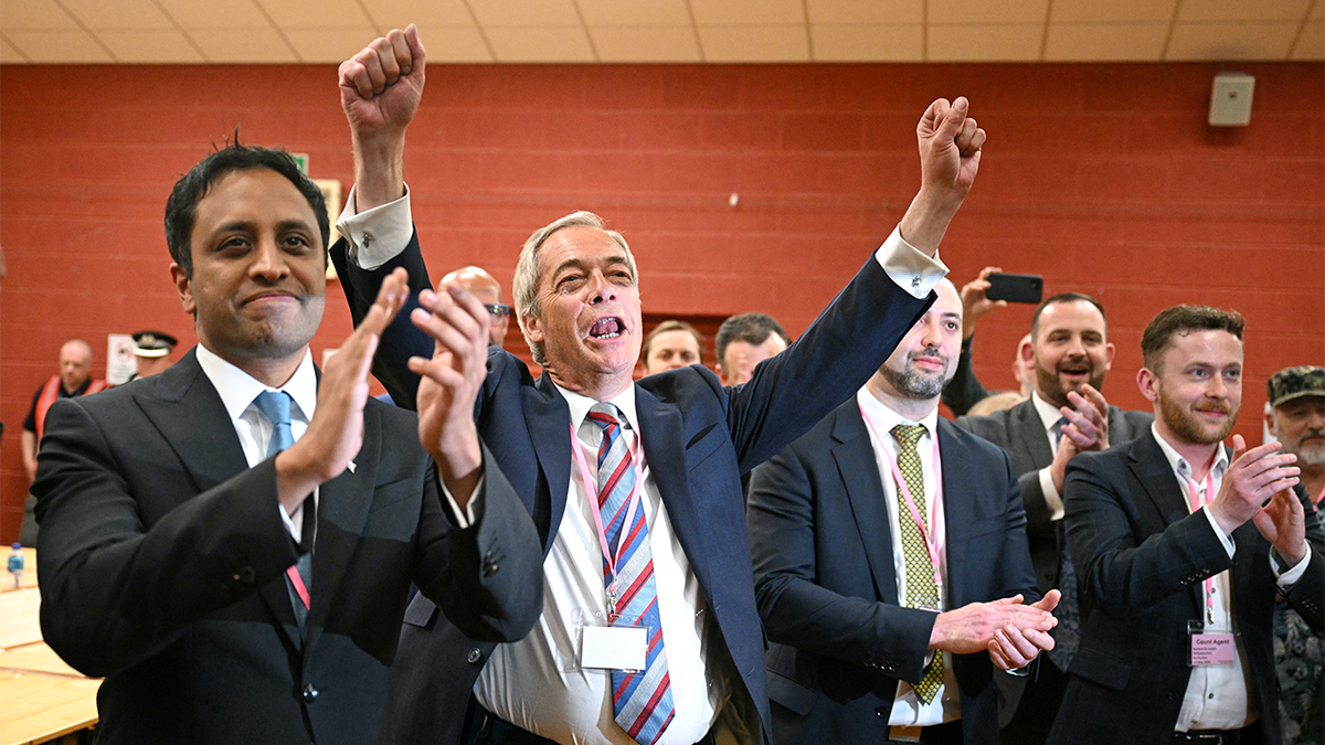 Nigel Farage celebrating with supporters at DCBL Stadium in Widnes