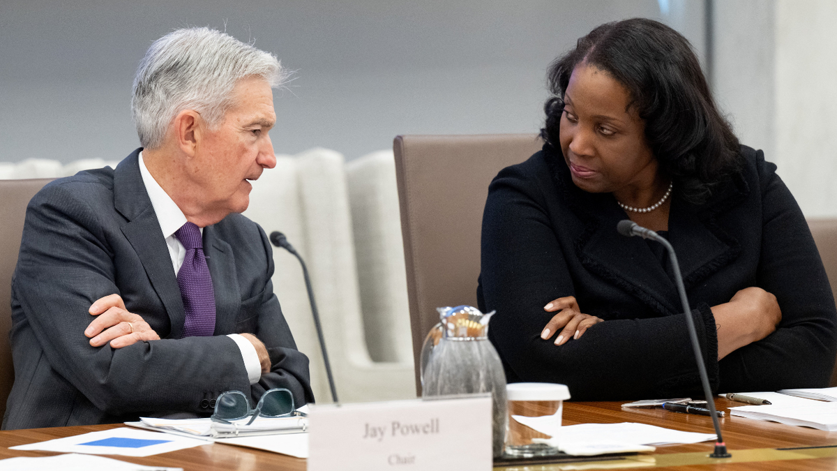 Chairman Jerome Powell speaking with Fed Governor Lisa Cook at Federal Reserve Board building in Washington, D.C.