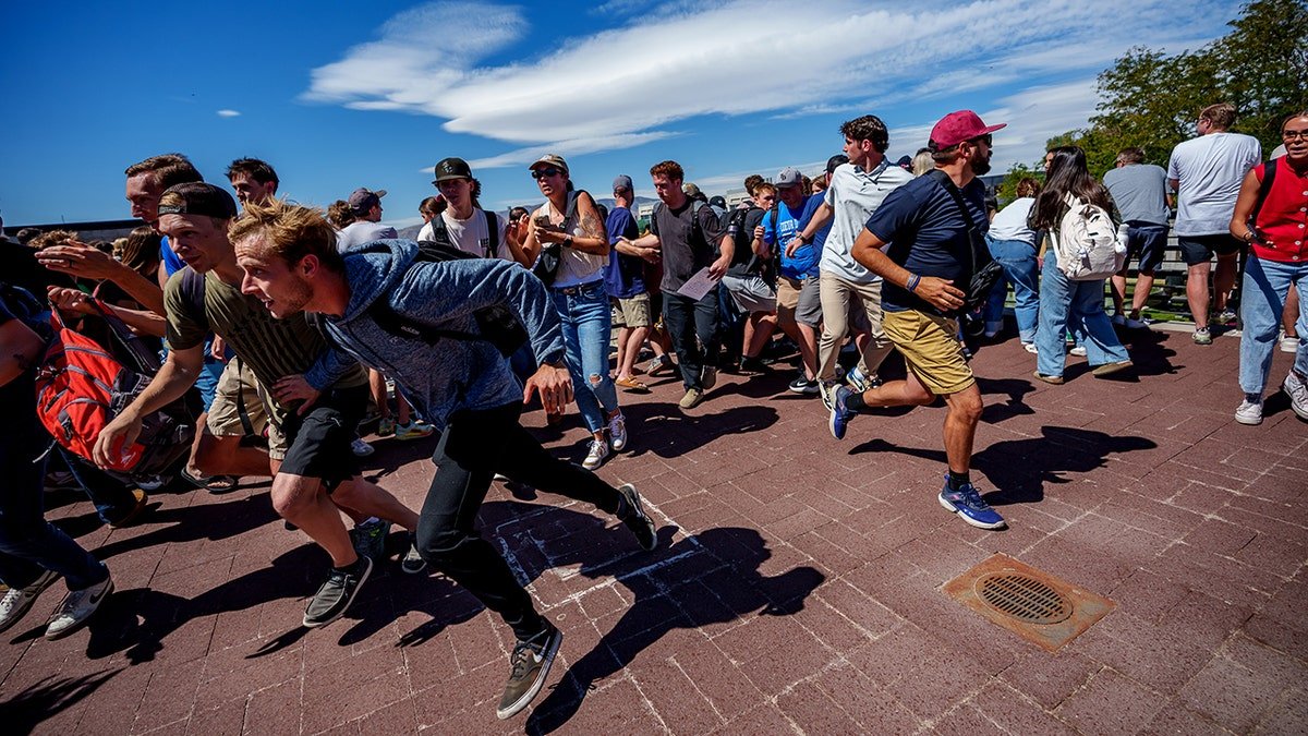 Charlie Kirk speaking at Utah Valley University event as people run after shots fired