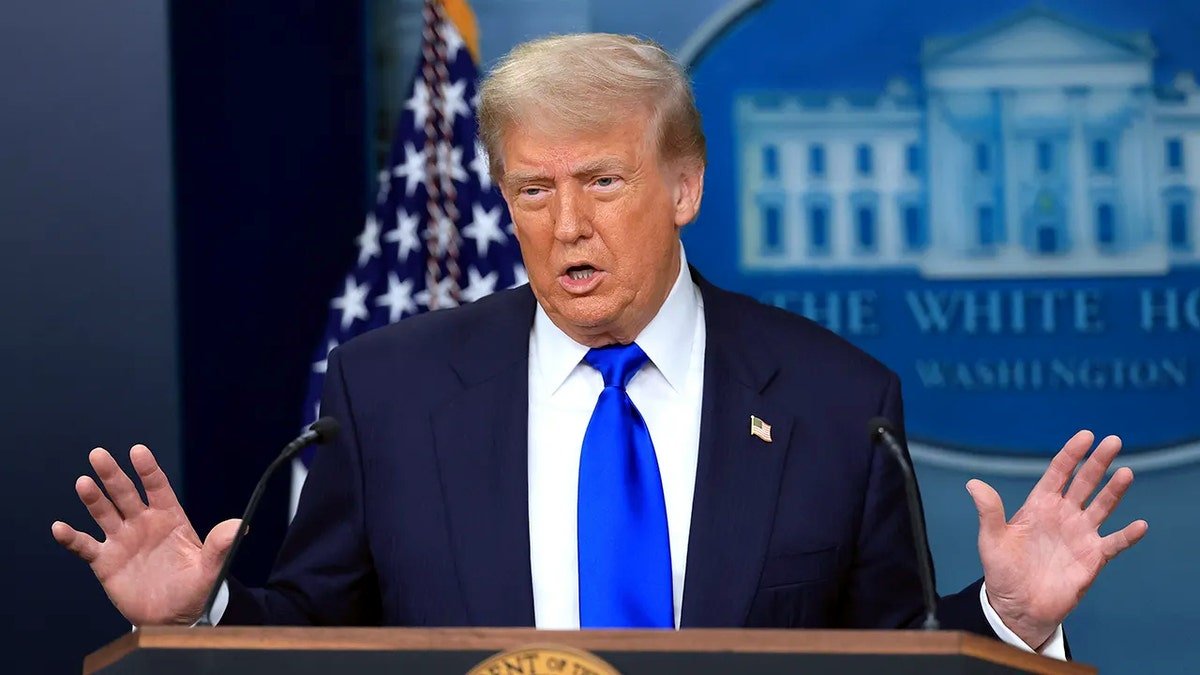 President Donald Trump speaking at a podium at the White House