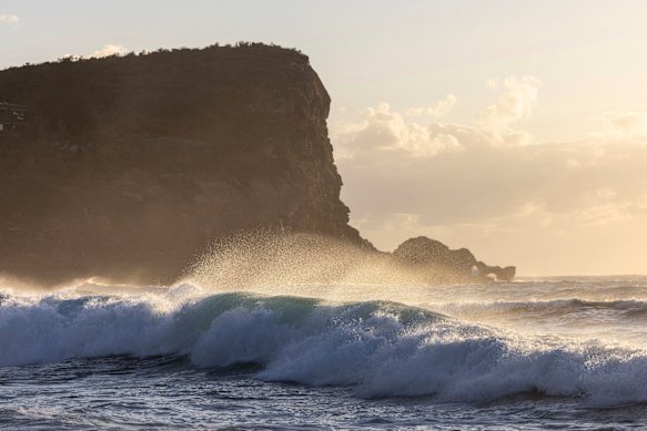 Sea sprays off the waves at Avalon Beach.