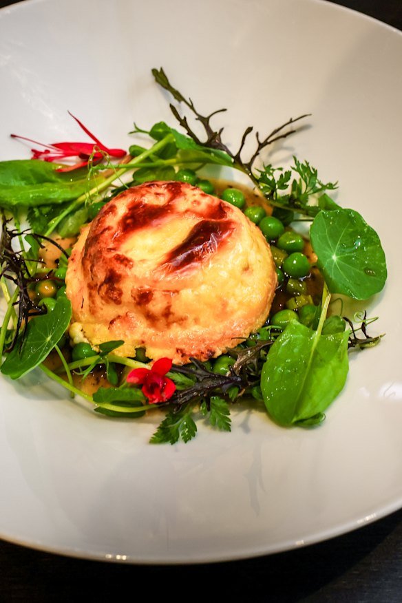 The Garden Restaurant’s twice baked gruyere souffle, asparagus, peas, truffle sauce.