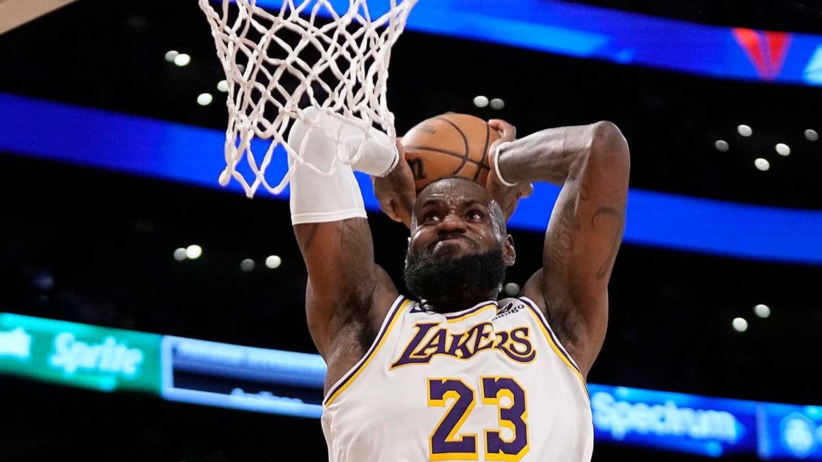 LeBron James dunking a basketball during a game.