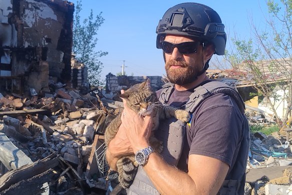 Campbell with the only rescued cat of 20 from a bombed home.