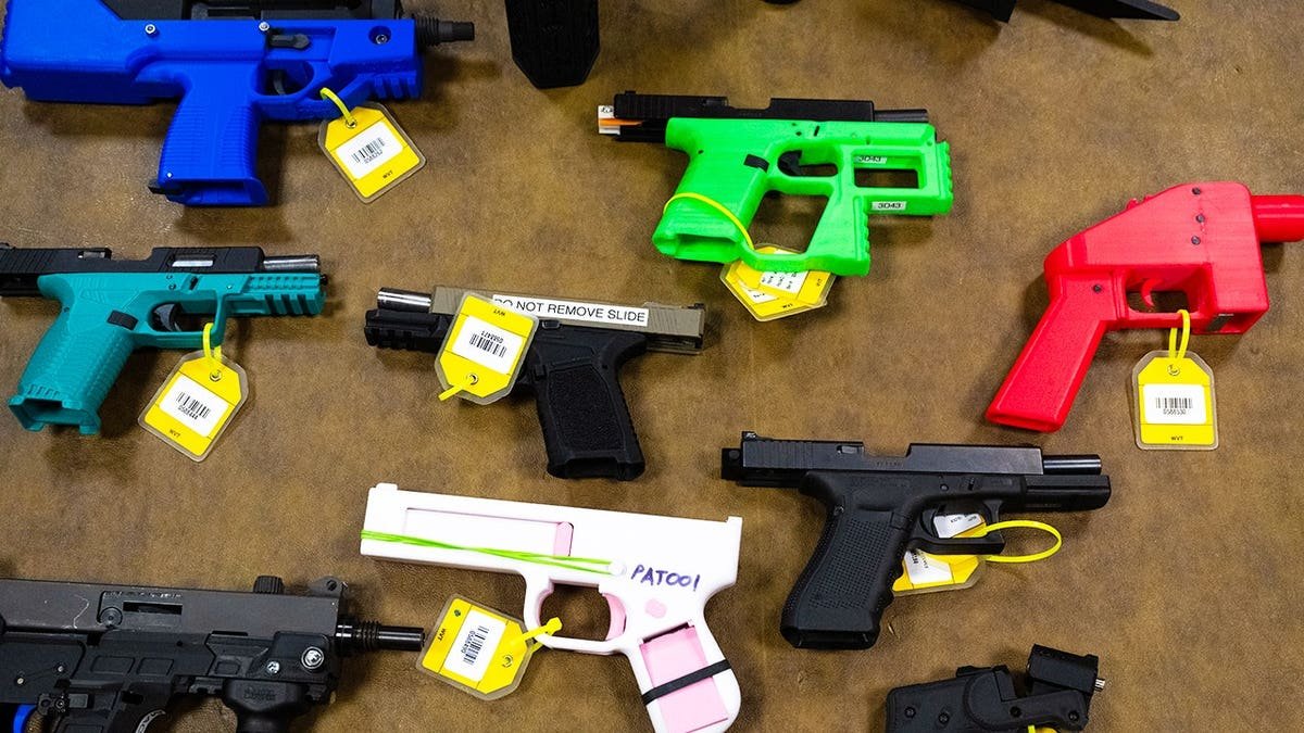 A collection of 3D printed guns and guns that have been modified using 3D printed parts, are seen in the National Firearm Reference Vault