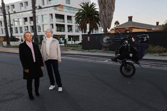 Port Melbourne residents Marion Sitter (left) and Heather Brown and a motorcyclist who sped behind them while they were being photographed.