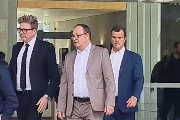 Mark Sheridan Waden (centre) leaves court with his legal team James Godbolt (right) and Nick Dore (left).
