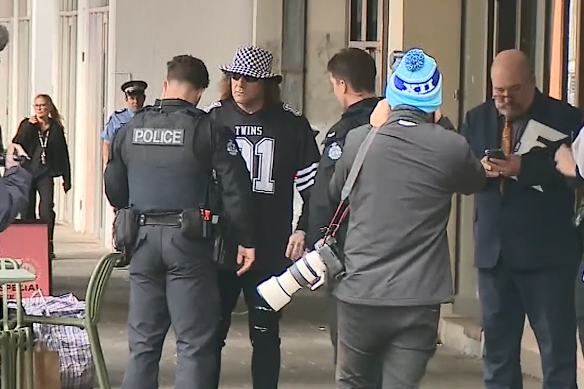 Troy Mercanti being checked over by gang crime squad members before his court appearance on Tuesday. 