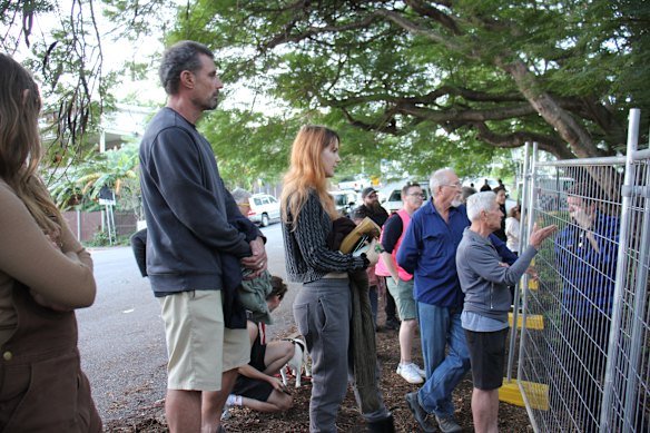Protesters gather outside the fences at Kurilpa Commons on the border of Highgate Hill and West End.