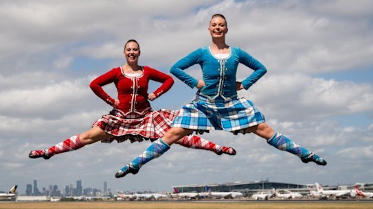 Macey Bennett and Sian Roach, highland dancers in the Royal Edinburgh Military Tattoo on the tarmac at Brisbane International Airport, February 6, 2026.
