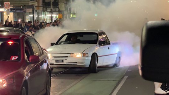 A car does a burnout on Chapel Street on Saturday night. 