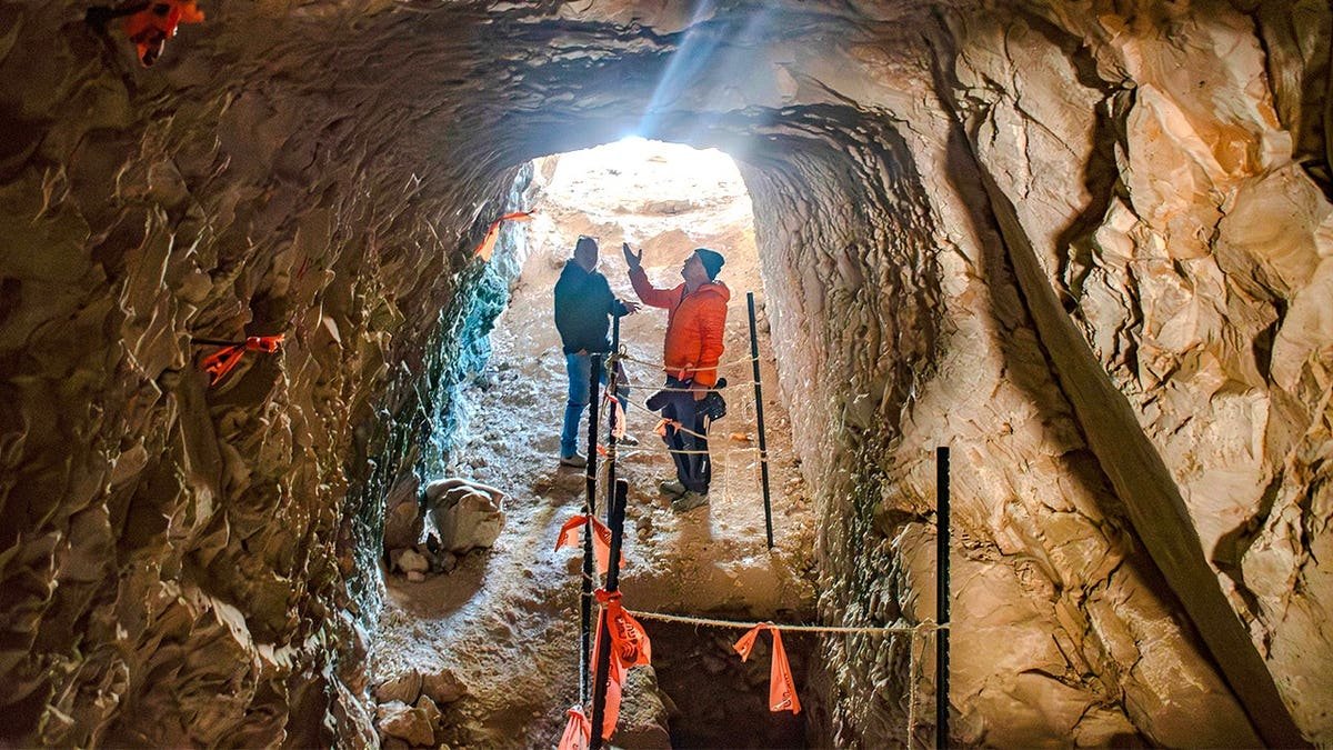 Archaeologists standing beneath ancient tunnel in Jerusalem