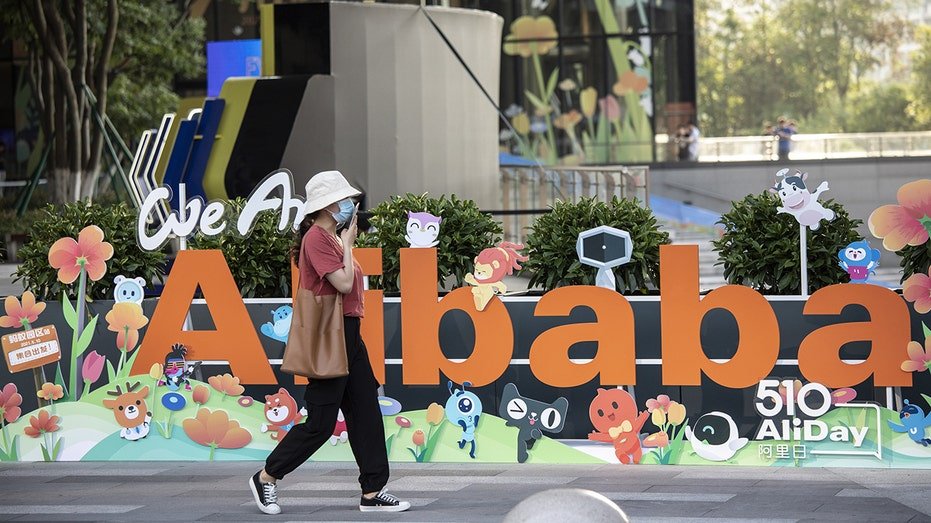 People walk past the Alibaba headquarters.