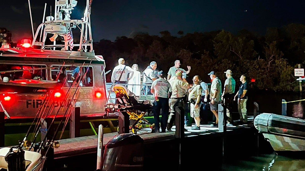 Miami-Dade Fire Rescue agents standing at the scene of a boat crash near Boca Chita Key Florida