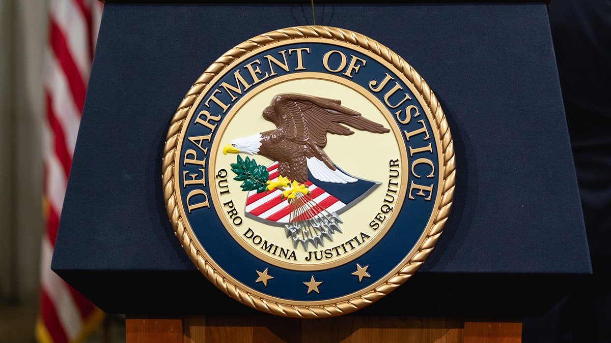 A a podium with the Department of Justice seal in Washington, D.C.
