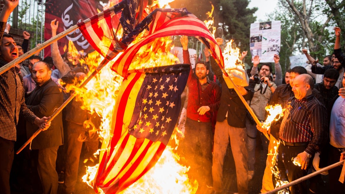 Iranians burning American flags outside former U.S. embassy in Tehran