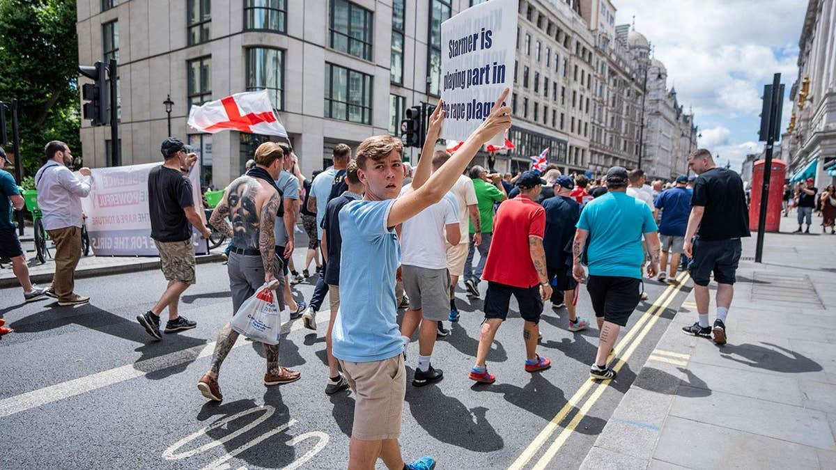 protestor holds a placard accusing the Prime Minister Sir Keir Starmer of ignoring the Grooming Gang scandal during a rally
