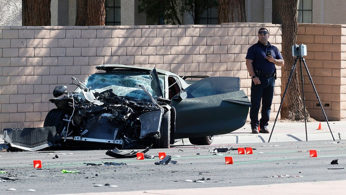 Las Vegas Raiders wide receiver Henry Ruggs III standing next to a Chevrolet Corvette at a crime scene