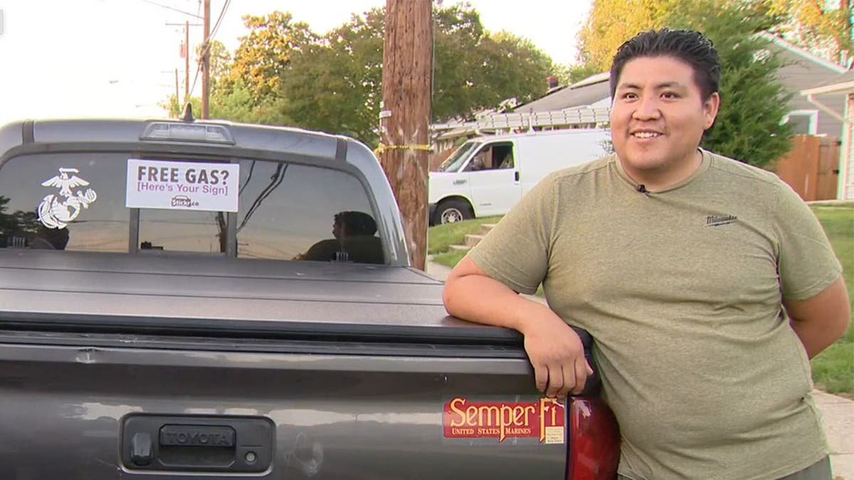 photo shows Borda standing next to the bed of his pickup truck