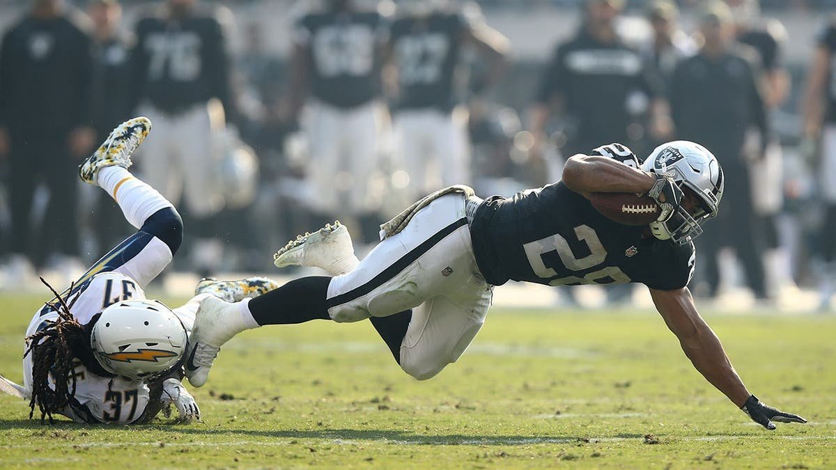 Doug Martin is tackled by Jahleel Addae during an NFL game