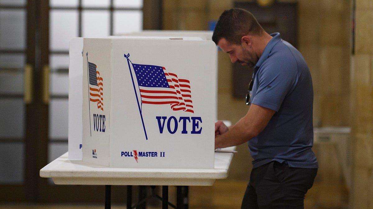 A voter filling out a mail-in ballot at the Board of Elections office in Pittsburgh, Pennsylvania
