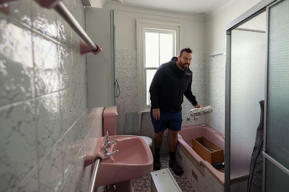 Symes in the existing pink bathroom.