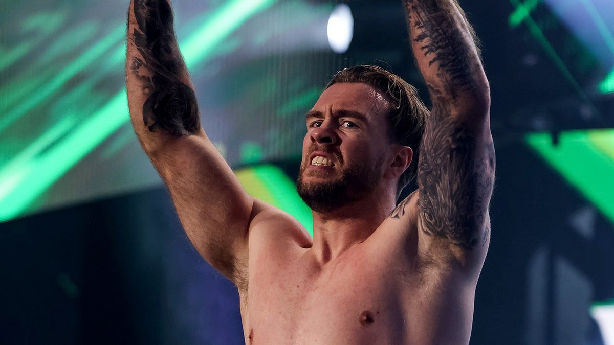 Will Ospreay standing in the wrestling ring at AEW Revolution event.