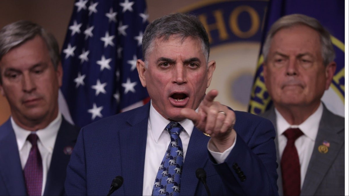 Rep. Andrew Clyde exults and points during a news conference