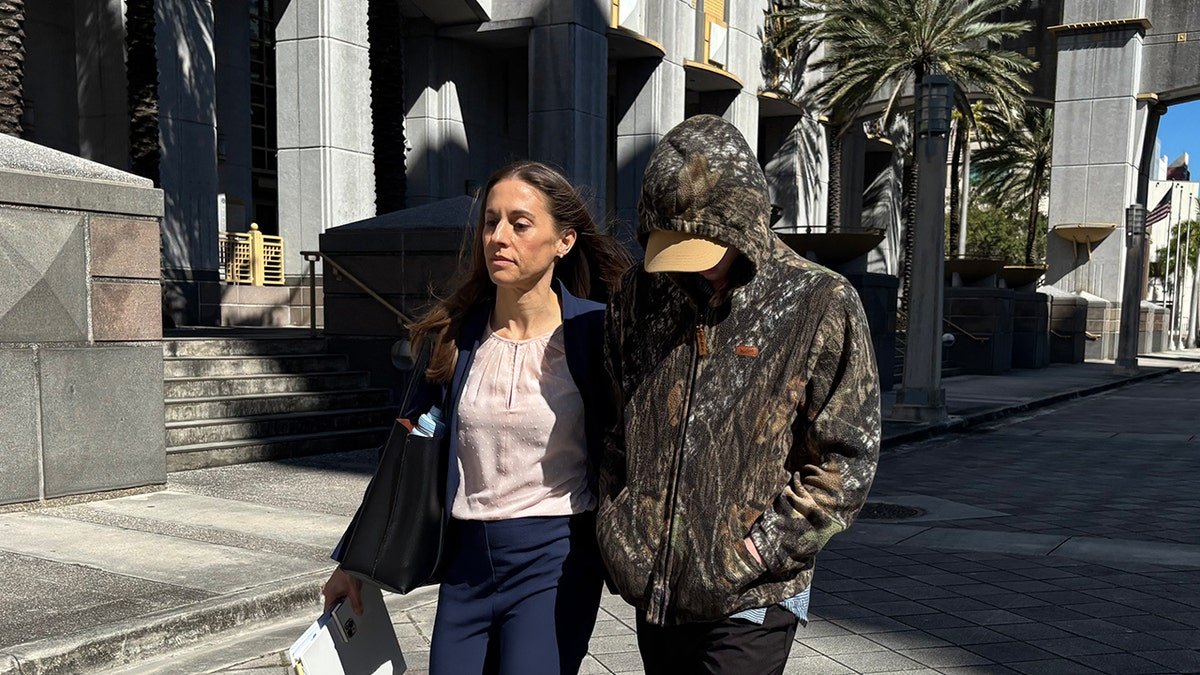 Anna Kepner's 16 year-old stepbrother walking outside a Federal Court building in Miami with his attorney