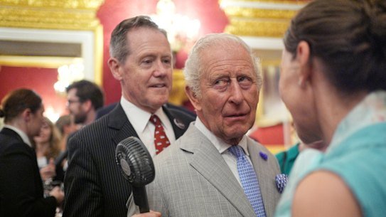 Charles gets fan assistance from senior aide Vice Admiral Sir Tony Johnstone Burt at the St James’s Palace reception.