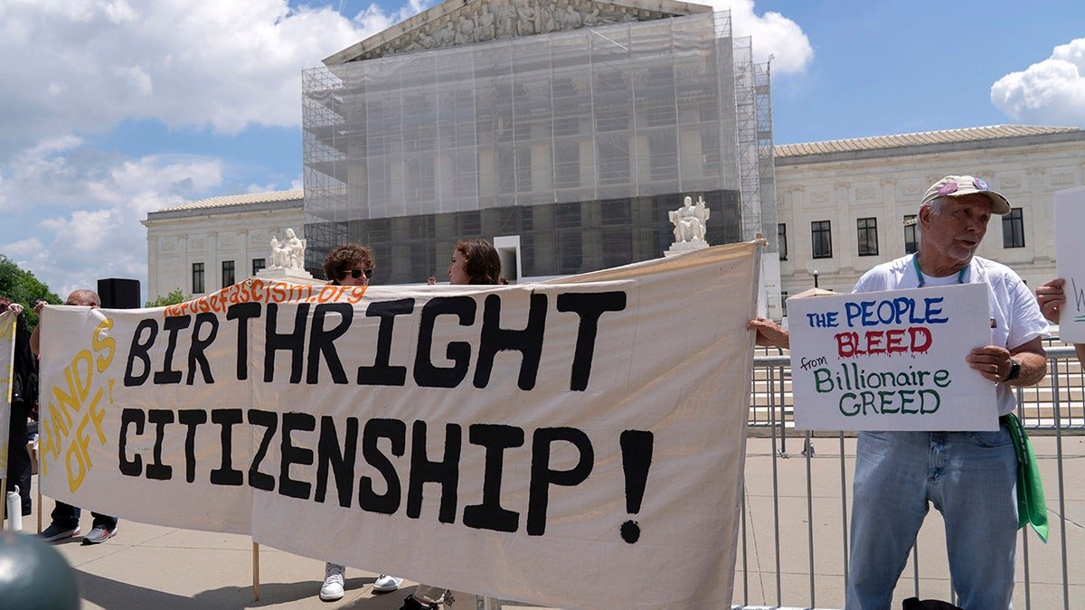 Demonstrators holding a banner outside the Supreme Court in Washington