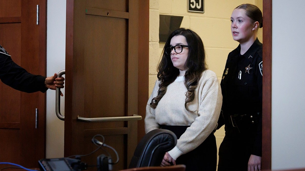 Juliana Peres Magalhães escorted into a courtroom in Fairfax, Virginia