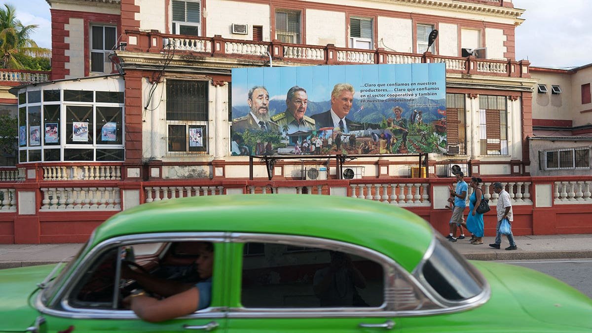 Poster of late Cuban President Fidel Castro, Cuba's former President Raul Castro and Cuba's President and First Secretary of the Communist Party Miguel Diaz-Canel