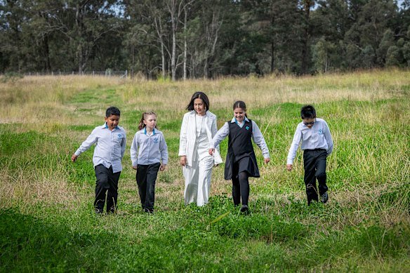 Deputy Premier Prue Car with students of Bella Vista Public School, on the site of their future high school.