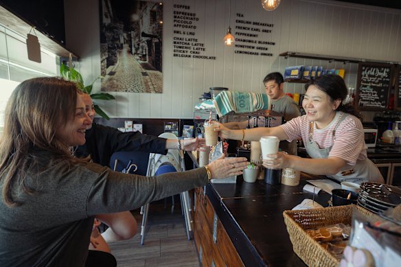 Cafe owners Benson and Sophia Dong with customers Kylie and Abbey.