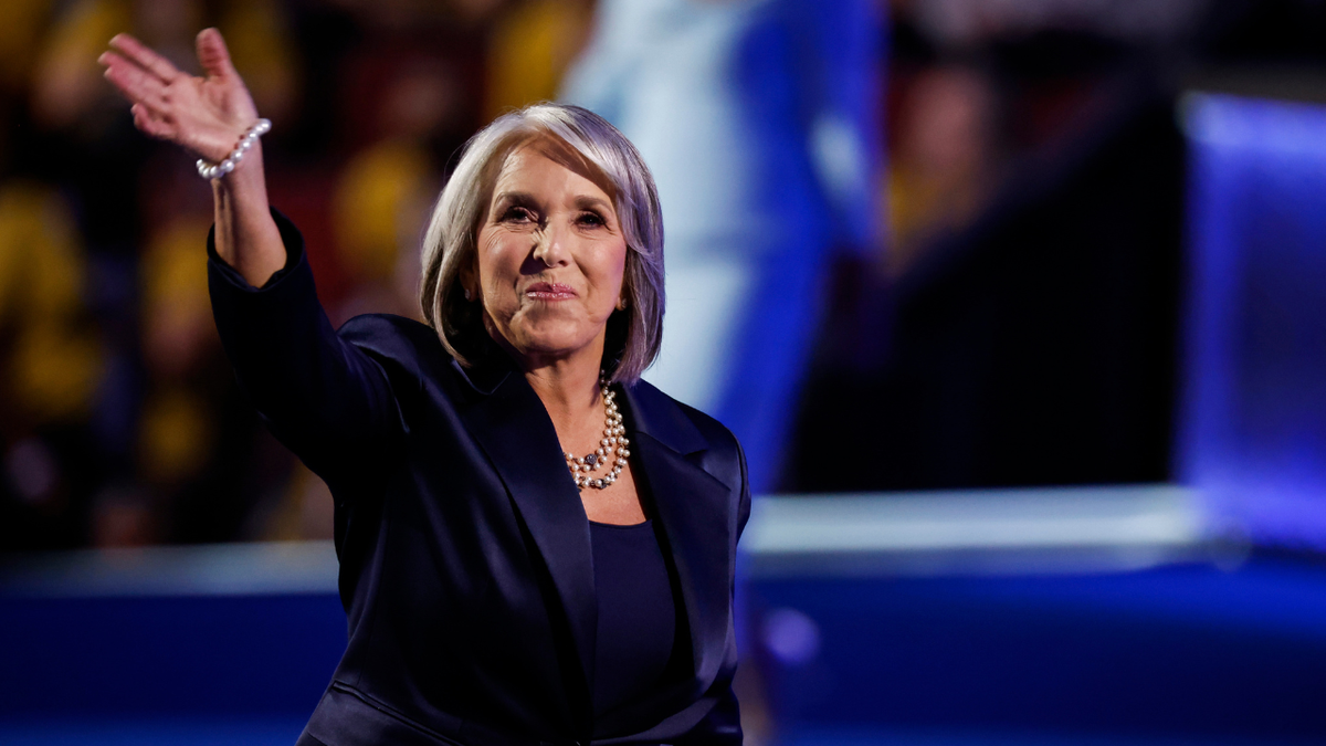 New Mexico Gov. Michelle Lujan Grisham waves to a crowd of supporters.