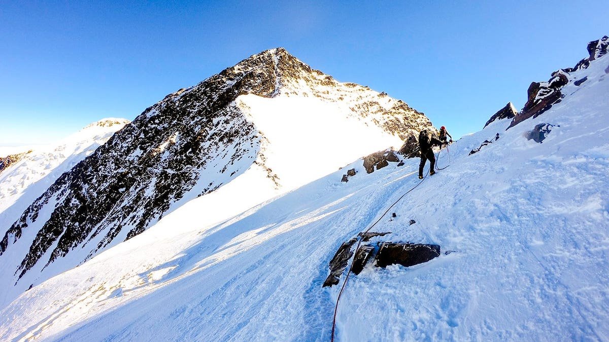 Male climber standing on a snowy slope in Denali National Park Alaska