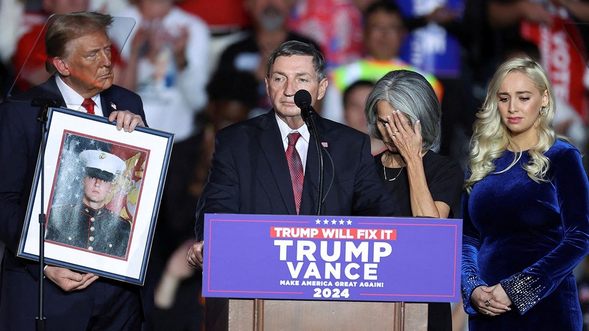 Republican presidential nominee Donald Trump holding a portrait of Nicholas Douglas Quets at a rally in Henderson, Nevada