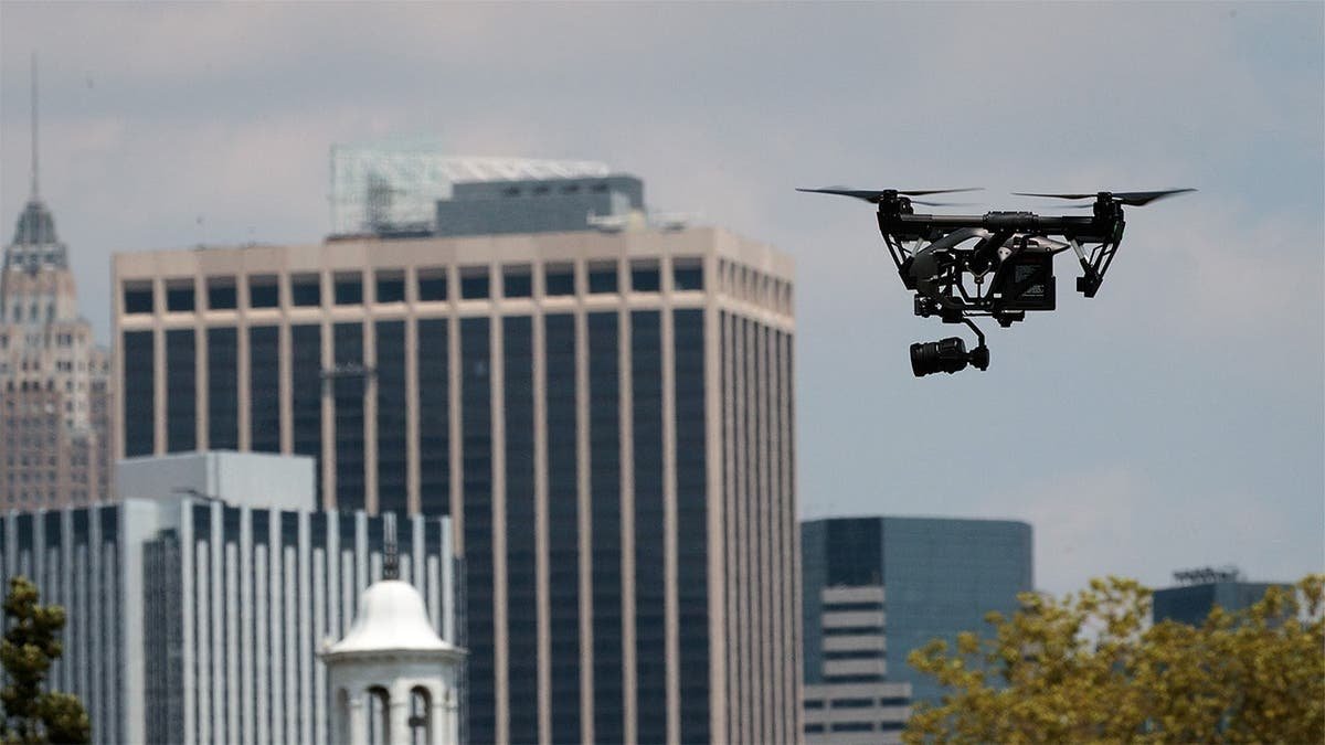 A drone hovers over buildings