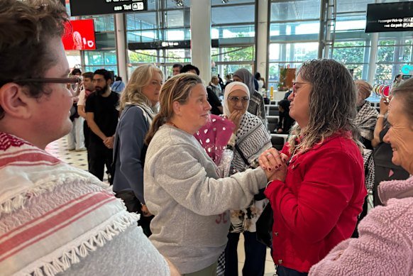 Helen O’Sullivan (centre) arriving back in Brisbane in May.