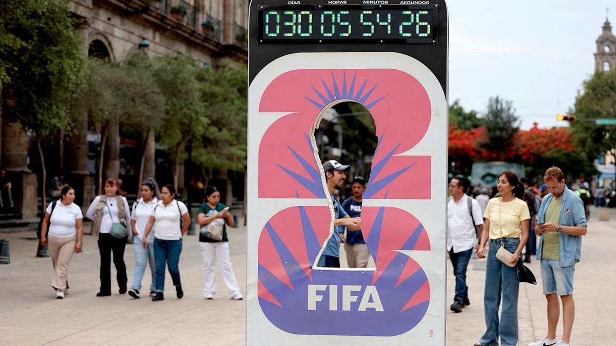 A clock marking 30 days to the 2026 FIFA World Cup in Guadalajara, Mexico with people walking nearby