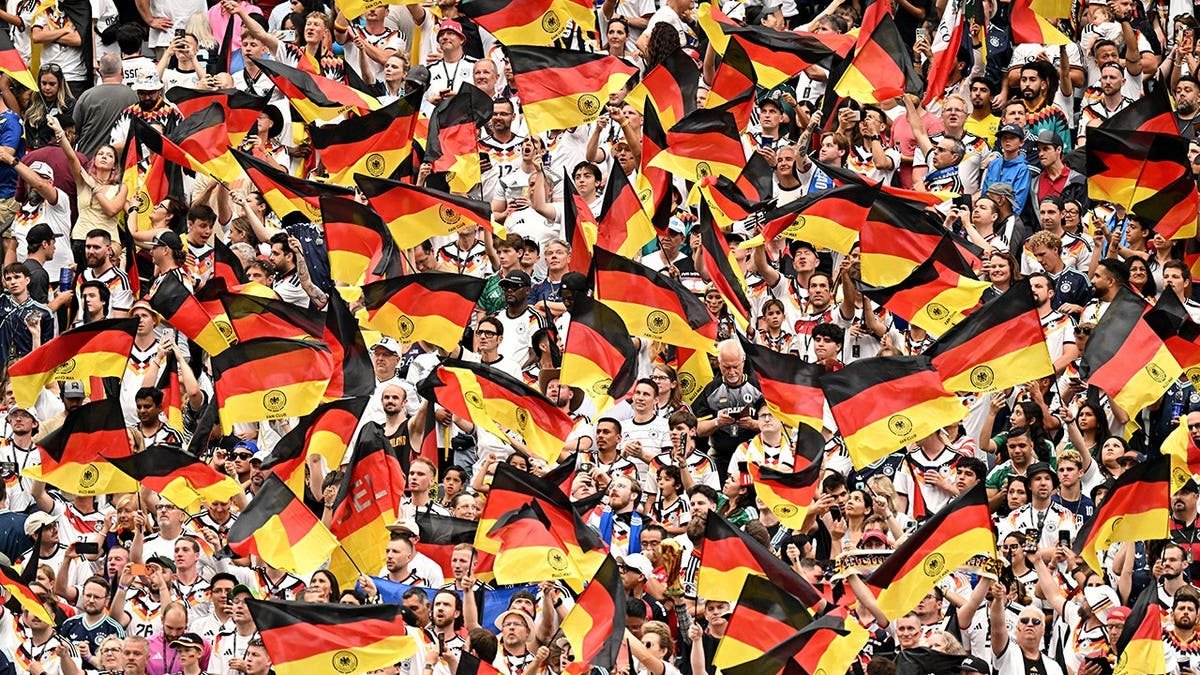Germany fans seated in the stands at a sports event.