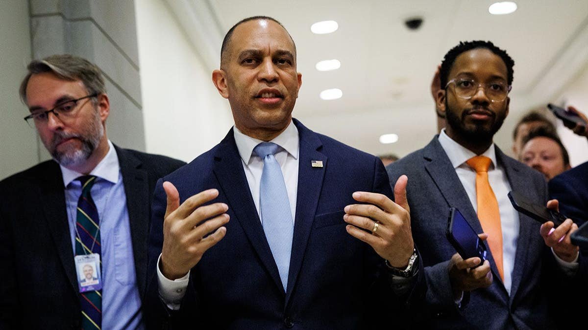 U.S. House Minority Leader Hakeem Jeffries walking and speaking with reporters at the U.S. Capitol