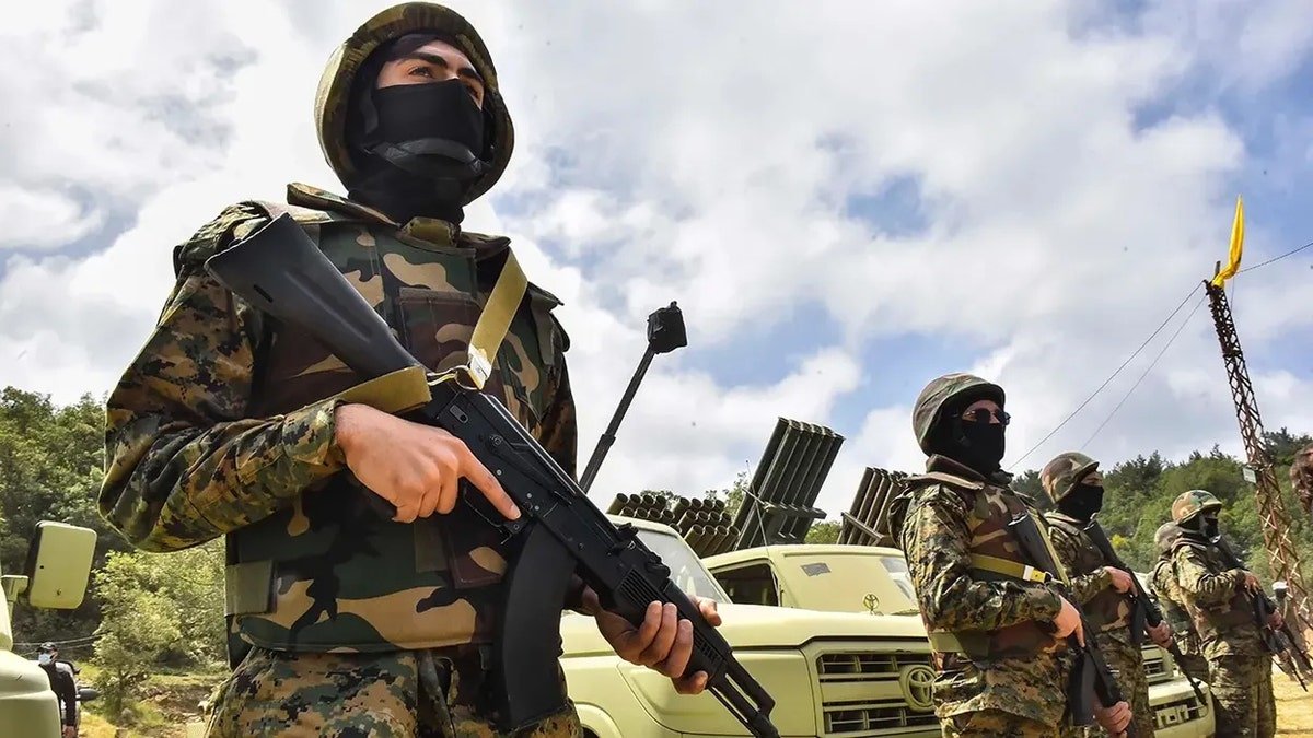 Hezbollah terrorists holding rifles in a group