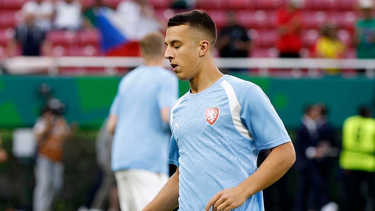 Czech Republic midfielder Hugo Sochurek warming up on the field.